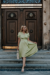 a lady in a green v-neck dress